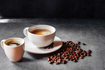 Espresso coffee cup with Americano coffee shot and roasted coffee beans on gray background