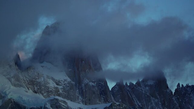 Time-lapse of Mount Fitz Roy with vivid orange clouds at sunrise in Patagonia. Scenic nature background. El Chalten, Los Glaciares National Park