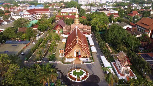 establishing over ornate golden rooftops of Wat Phra Singh temple in Chiang Mai, Thailand