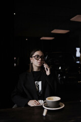 young woman drinking coffee in cafe