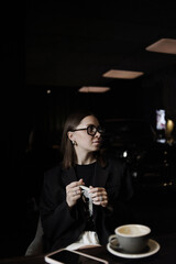young woman drinking coffee in cafe