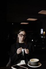 young woman drinking coffee in cafe