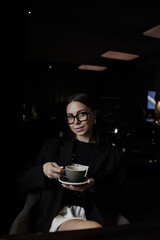 young woman drinking coffee in cafe