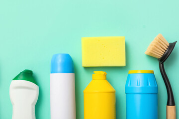 Set of cleaning supplies on green background