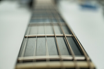 Close-up shot of a guitars fretboard showcasing craftsmanship, musical artistry, beauty of nature and human ingenuity, perfect for music advertisements or editorials