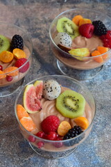 Silken tofu chocolate mousse dessert with mixed fresh fruits ( kiwi, dragon fruit, raspberry, blackberry, fig, orange, red currant, physalis). Vegan dessert