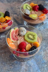 Silken tofu chocolate mousse dessert with mixed fresh fruits ( kiwi, dragon fruit, raspberry,...