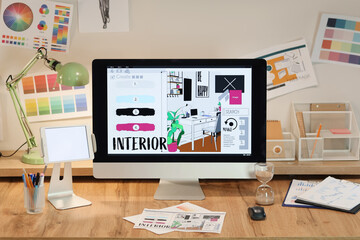 Interior designer's workplace with computer in office at night
