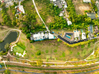 Obraz premium Aerial view drone shot of beautiful green golf field fairway and putting green,Top down image for sport background and travel nature background.