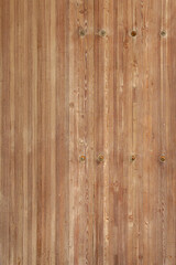 Naklejka premium Dark brown aged wooden planks with a rich. Their vintage surface carries the marks of years, adding warmth and character.