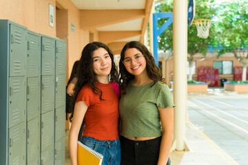 Two high school students smiling by lockers