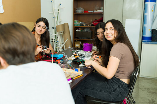 Group of high school students working on electronics project