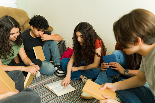 Group of high school students reading and studying together in book club