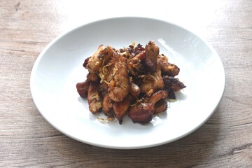 fried slice chicken meat with salt and garlic on plate