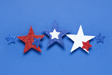 Glitter stars in colors of USA flag on blue background. Independence Day