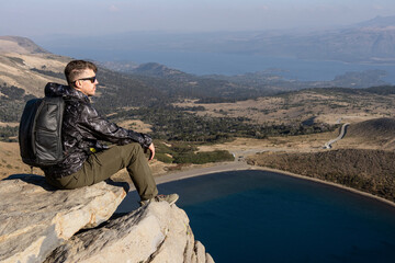 Caucasian Relaxing at Scenic Overlook of Batea Mahuida Viewpoint. Villa Pehuenia, Neuquen, Argentina