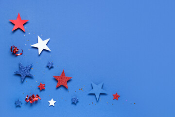 Paper stars with serpentines on blue background. Independence Day