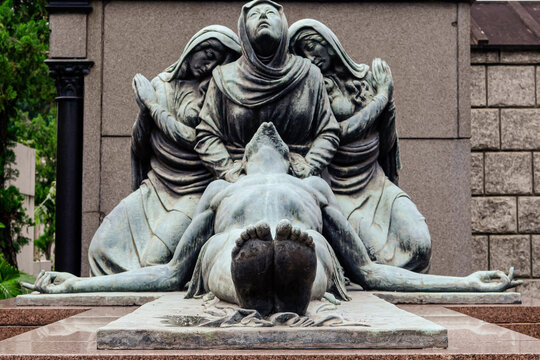 Statue of Our Lady in a tomb, accompanied by two angels in prayer, with Christ crucified in her arms. S&atilde;o Jo&atilde;o Batista Cemetery, Rio de Janeiro, Brazil.