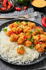 panko-breaded chicken bites with rice and sauce