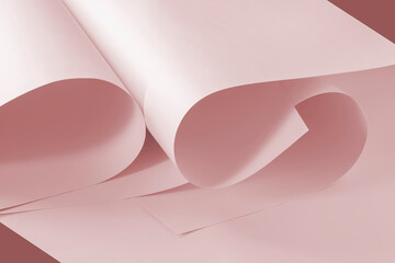 Pink sheets of paper as a background for creative design tasks.