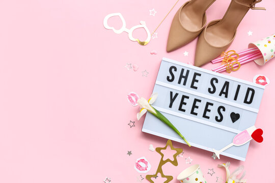 Board with text SHE SAID YES and decor for Hen Party on pink background