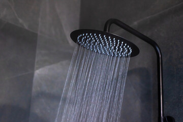 A sleek black shower head enhances your bathroom with cascading water