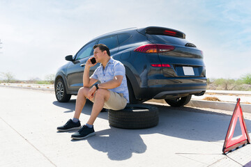 Stranded driver calling for roadside assistance on highway