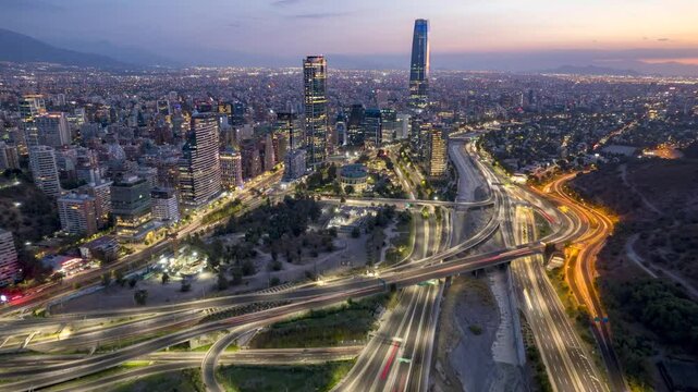 Santiago, Chile &ndash; February 21, 2024. Frontal drone flight above Mapocho River towards Costanera Center and Mountains at sunset.