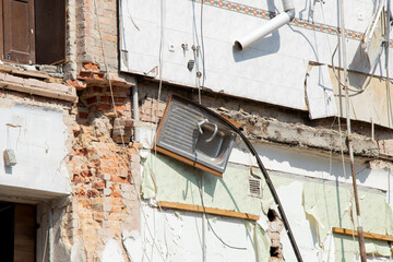 Destroyed residential building after missile strike in Ukraine, collapsed wall and damaged floors, consequence of war