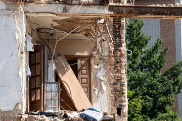Destroyed residential building after missile strike in Ukraine, collapsed wall and damaged floors,...