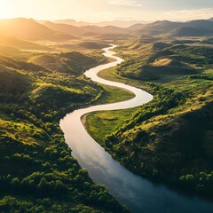 Scenic river flowing gracefully through serene valley with lush green vegetation and clear blue sky