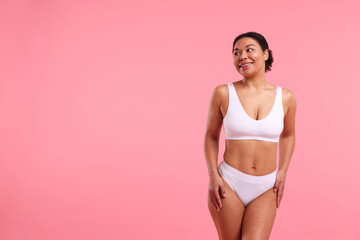 Naklejka premium Woman in underwear with smooth skin after epilation procedure on pink background, space for text