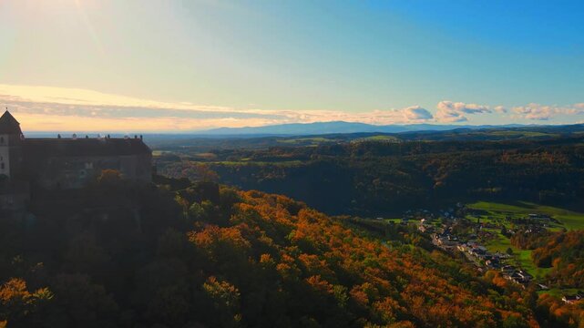 Aerial view of the historic Bernstein Castle (Burg Bernstein) in Austria. Scenic drone shot of the medieval fortress surrounded by forest and hills in the Burgenland region. 
