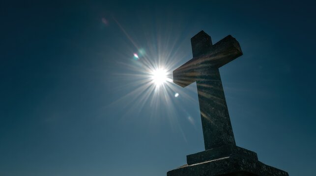 The striking contrast between the dark cross and the bright sunlight evokes a sense of hope and triumph over darkness.