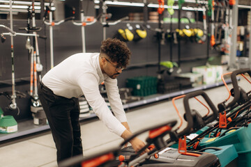 Professional Worker Arranging Equipment in a Store Display Area