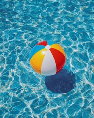 Beach ball floating in clear pool water