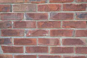 Red brick wall pattern background with tan mortar or grout.