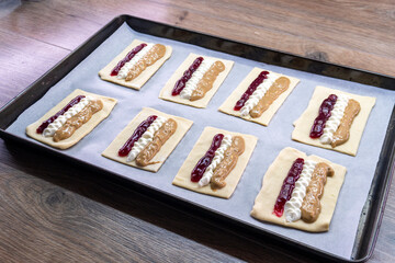 Puff pastry tarts with cream cheese, cherry jam, peanut butter. Dessert. pastry