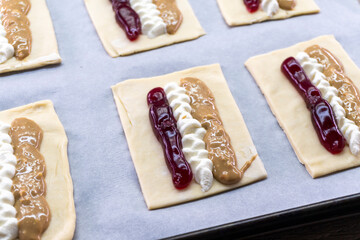 Puff pastry tarts with cream cheese, cherry jam, peanut butter. Dessert. pastry