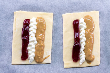 Puff pastry tarts with cream cheese, cherry jam, peanut butter. Dessert. pastry