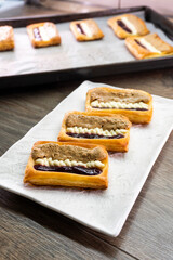 Puff pastry tarts with cream cheese, cherry jam, peanut butter. Dessert. pastry