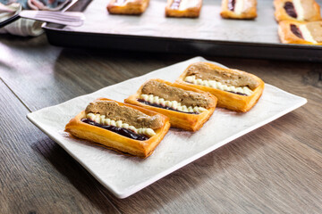 Puff pastry tarts with cream cheese, cherry jam, peanut butter. Dessert. pastry