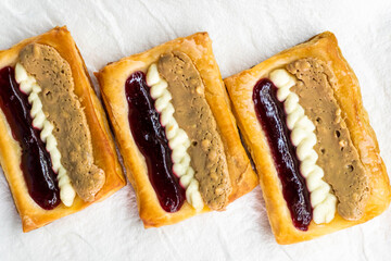 Puff pastry tarts with cream cheese, cherry jam, peanut butter. Dessert. pastry
