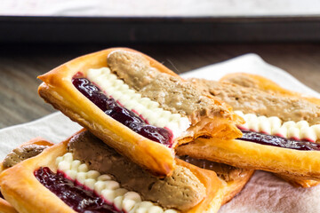 Puff pastry tarts with cream cheese, cherry jam, peanut butter. Dessert. pastry