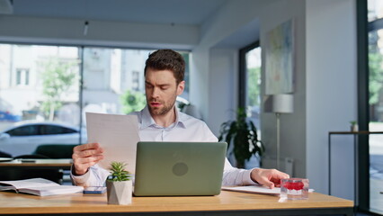 Obraz premium Business manager reading report at workspace closeup. Businessman dissatisfied 