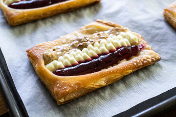 Puff pastry tarts with cream cheese, cherry jam, peanut butter. Dessert. pastry