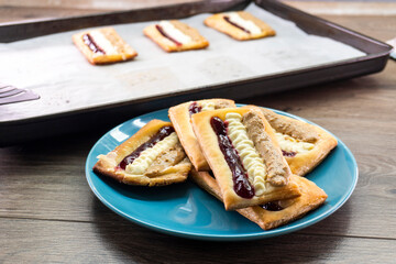 Puff pastry tarts with cream cheese, cherry jam, peanut butter. Dessert. pastry