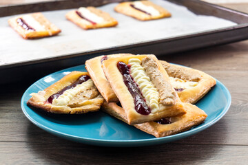 Puff pastry tarts with cream cheese, cherry jam, peanut butter. Dessert. pastry