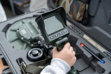 High-tech detection device being handled during equipment check at training facility in a secure location