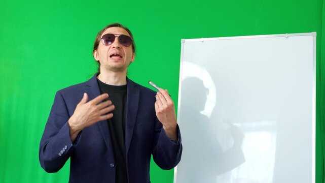 engaging and instructive mood as a man, dressed as a business coach, wearing sunglasses, holds a marker and gestures towards a whiteboard, ready for a presentation against a green screen background